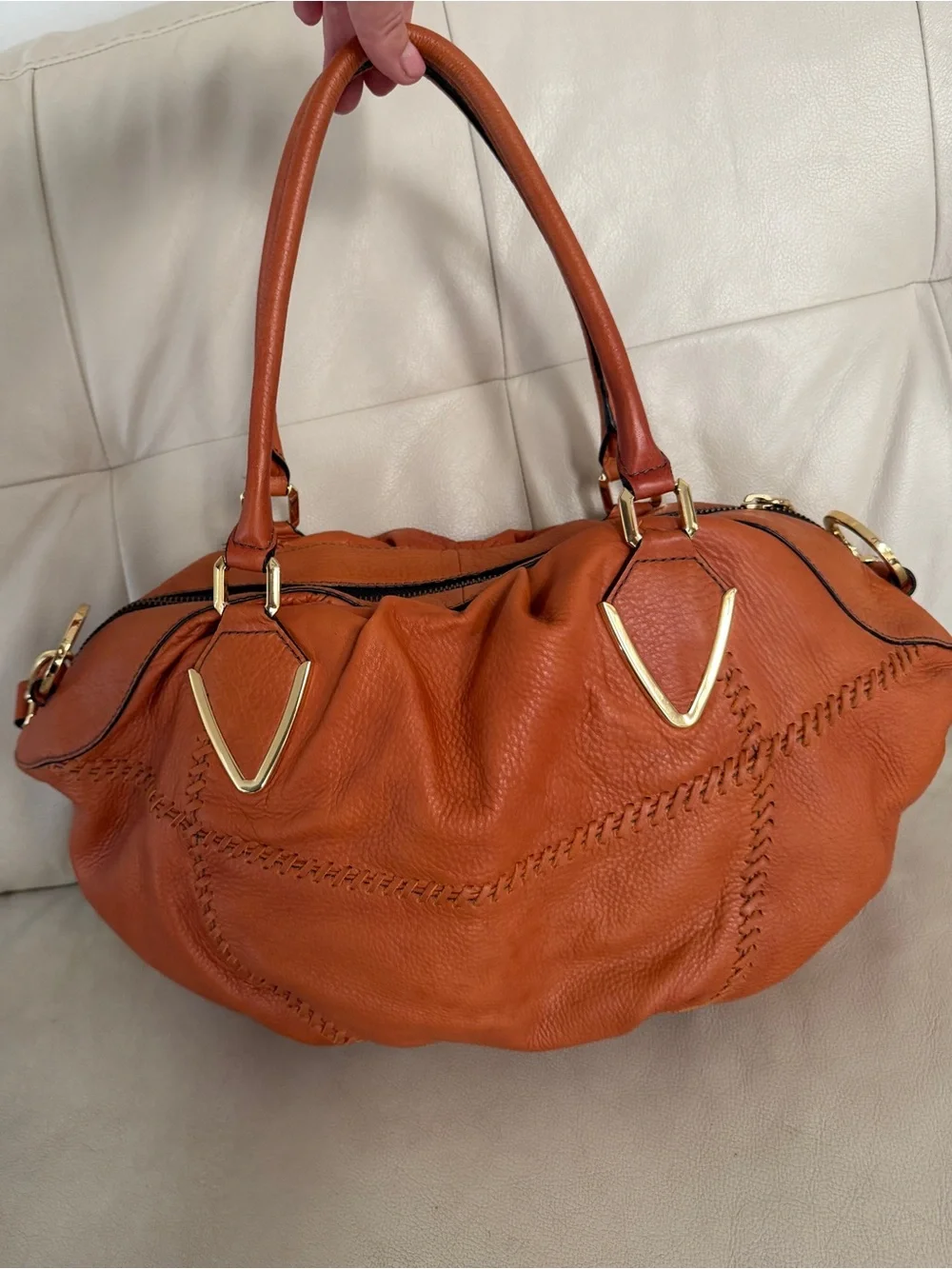 Orange leather handbag appears to be a slouchy style by orYany